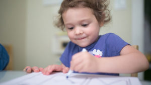Girl practicing letter writing at Wise Wonder New York City