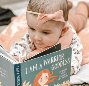 A baby reading a board book