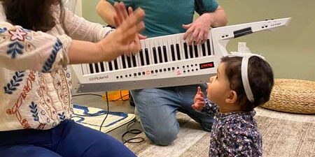 toddler learning music with a keytar